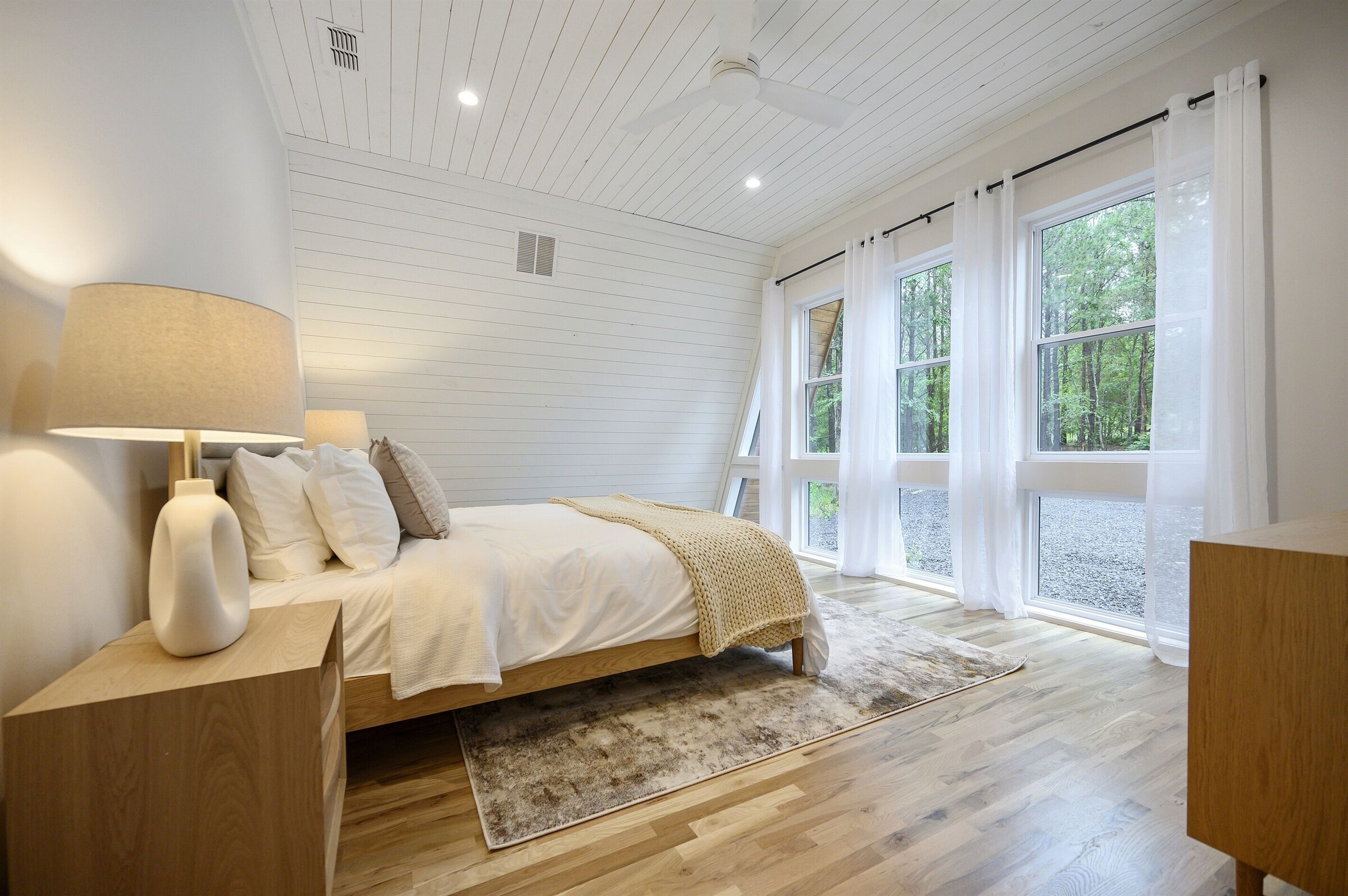 Bright bedroom with floor to ceiling windows
