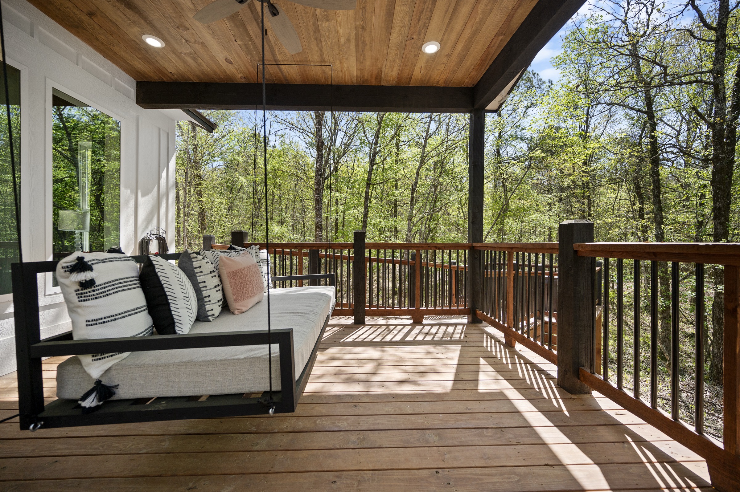 Covered deck with a hanging porch swing bed
