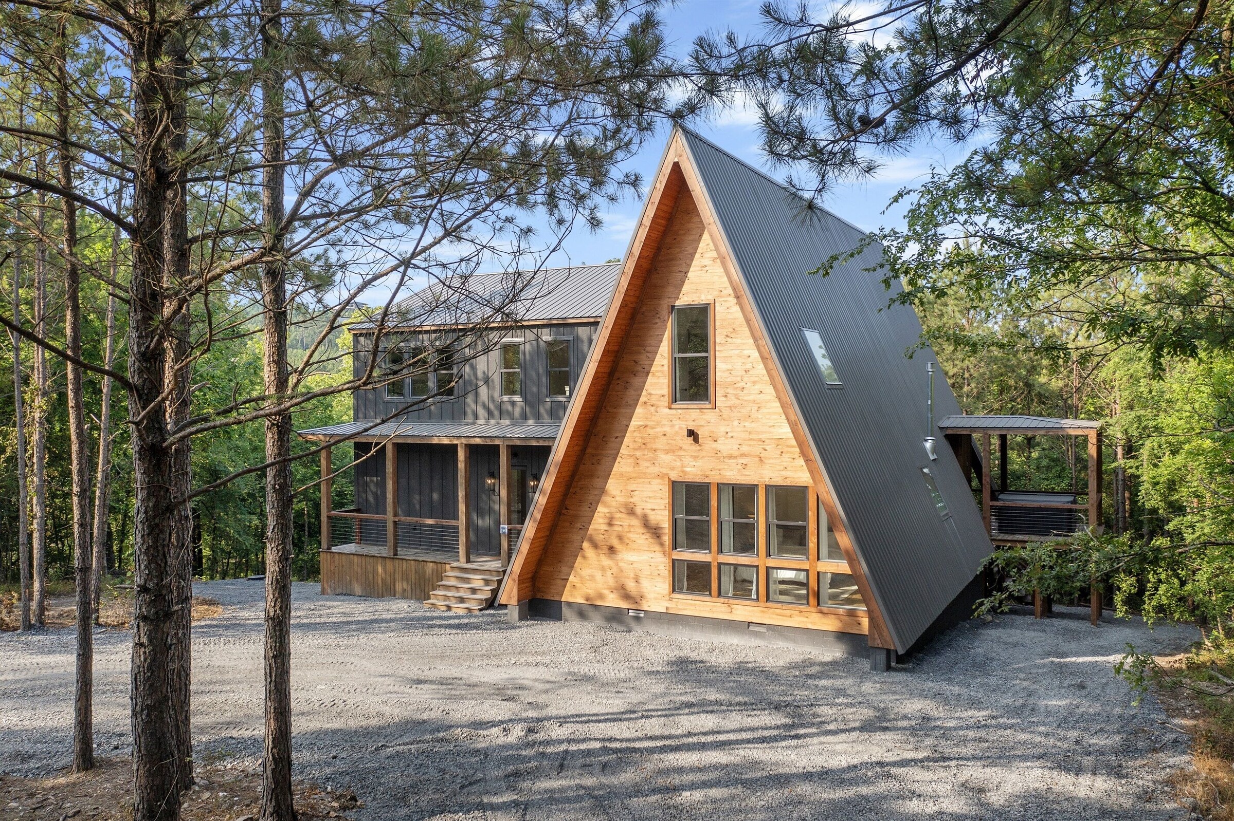 The A-frame exterior of Moonlight Peak surrounded by tall pines