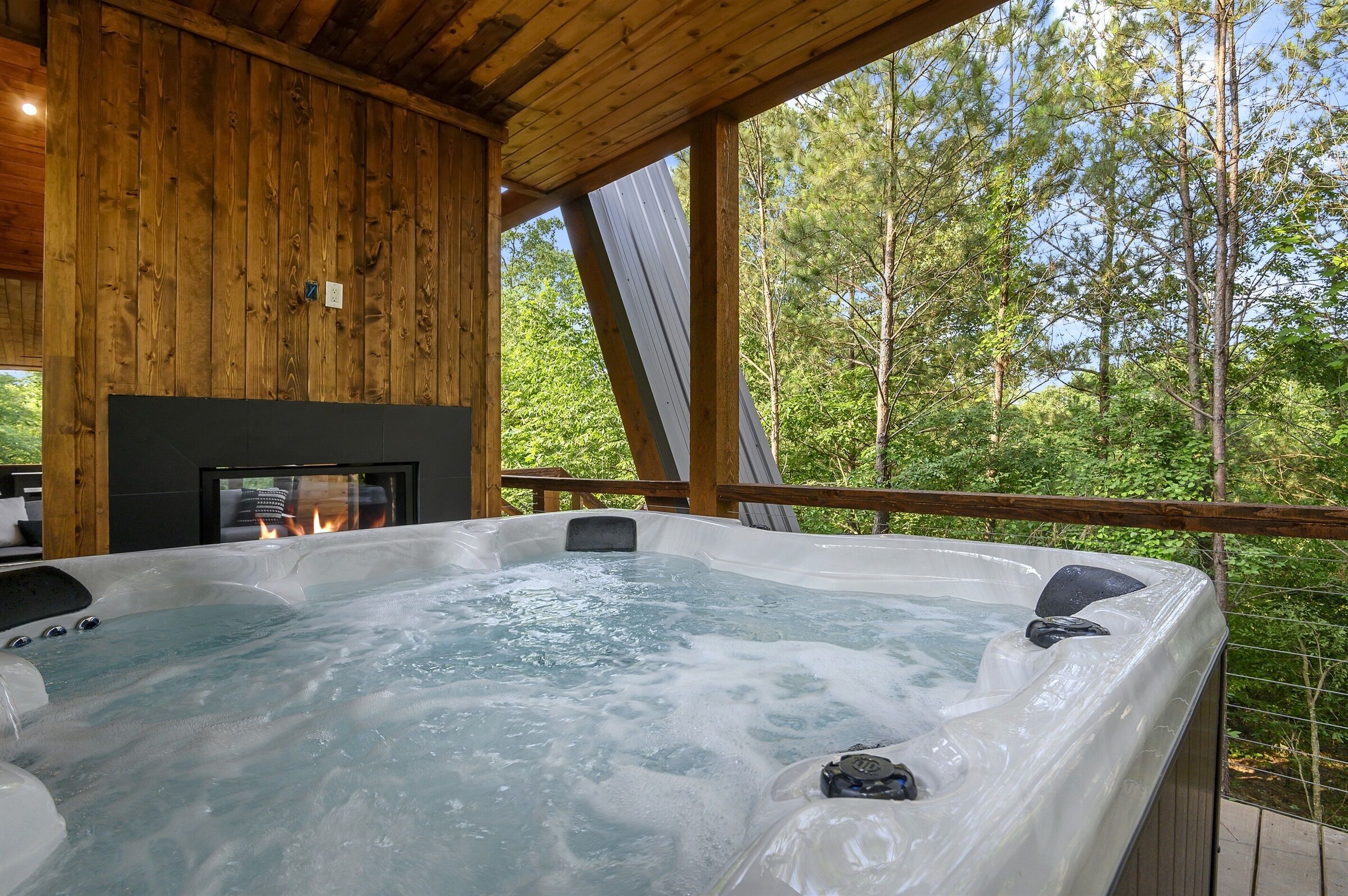 Eight person hot tub next to an outdoor fireplace