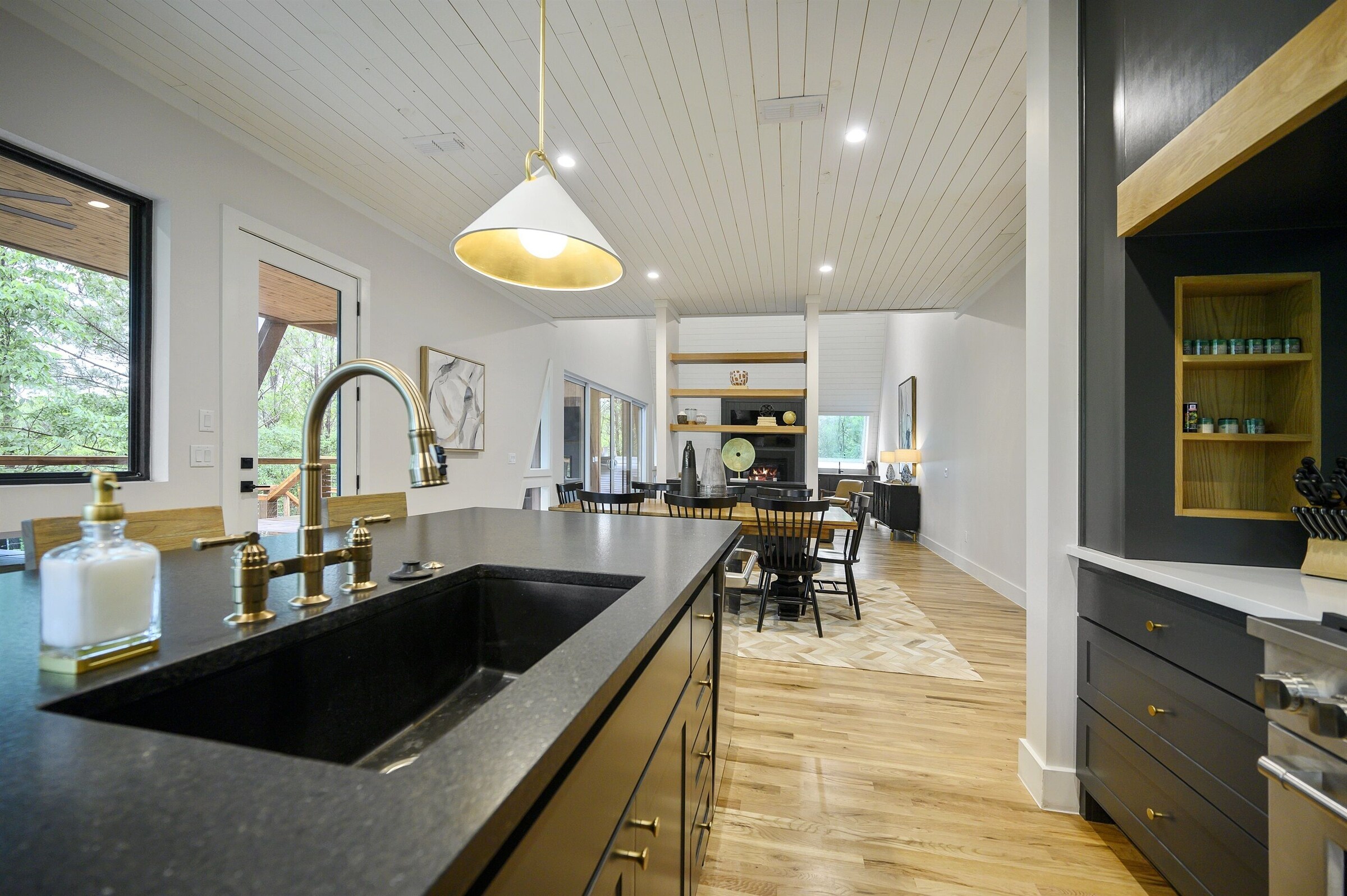 Kitchen with black counters and a large sink