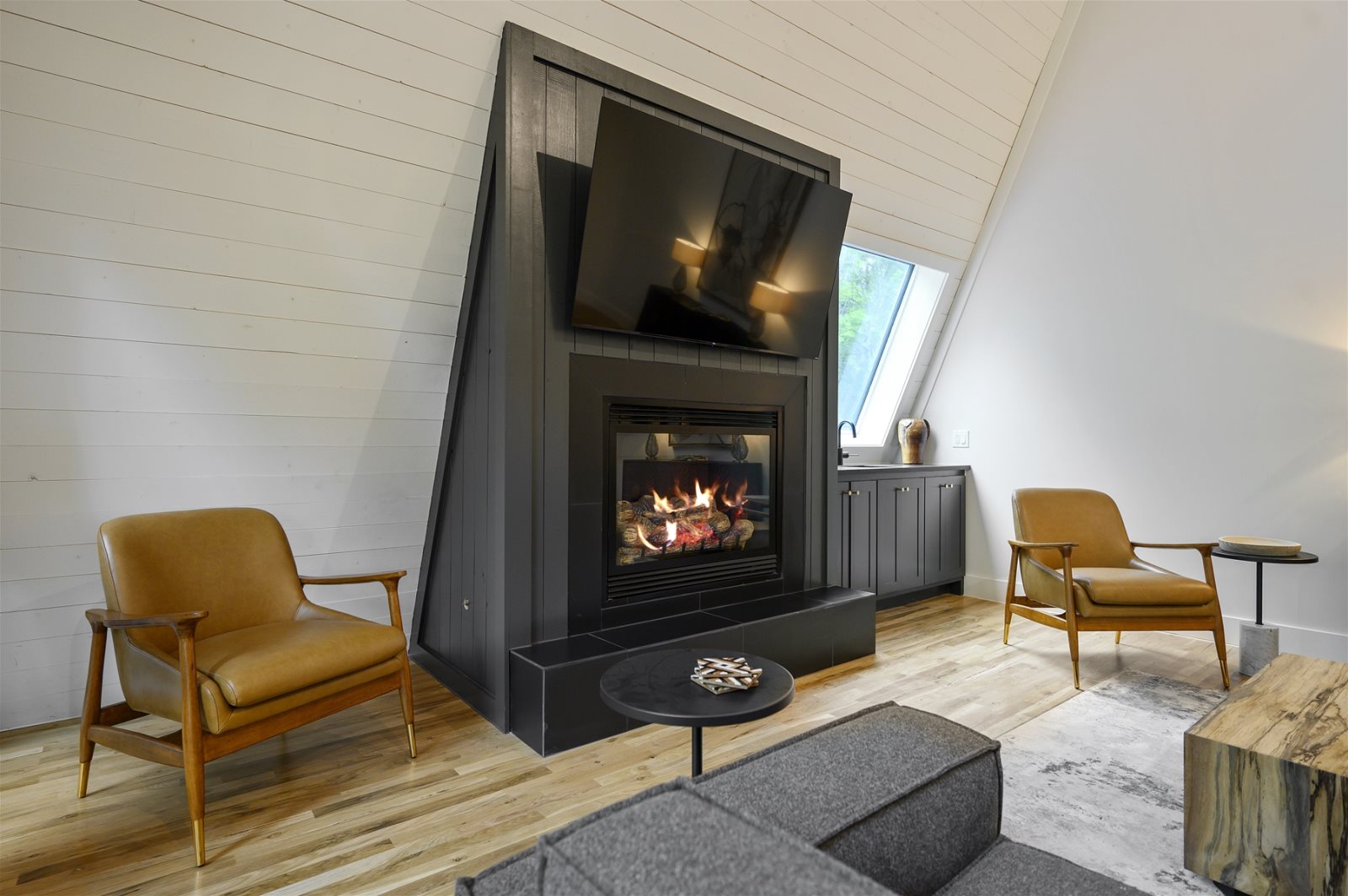 Sitting area with two chairs by the fireplace